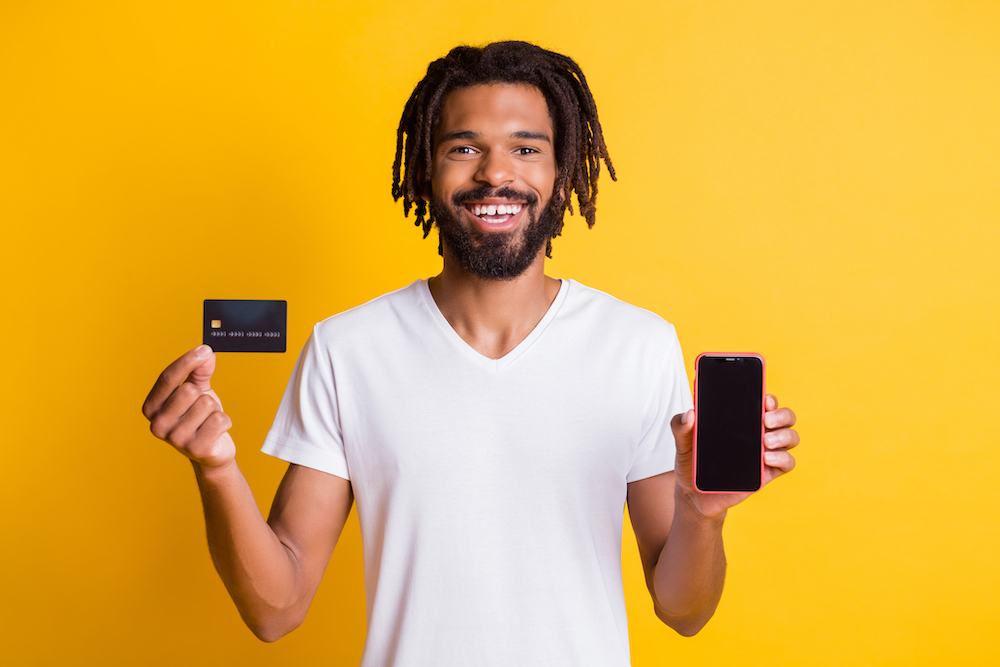 Guy Smiling Holding Credit Card