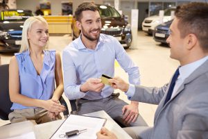 Couple buying car with credit card